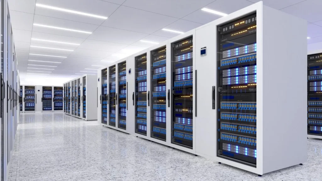 Rows of white server cabinets with illuminated equipment in a data center interior