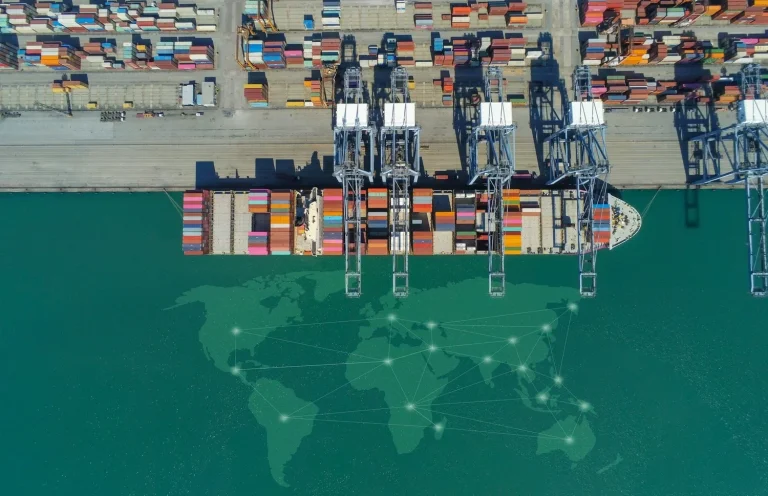 Container ship and loading cranes at a freight terminal