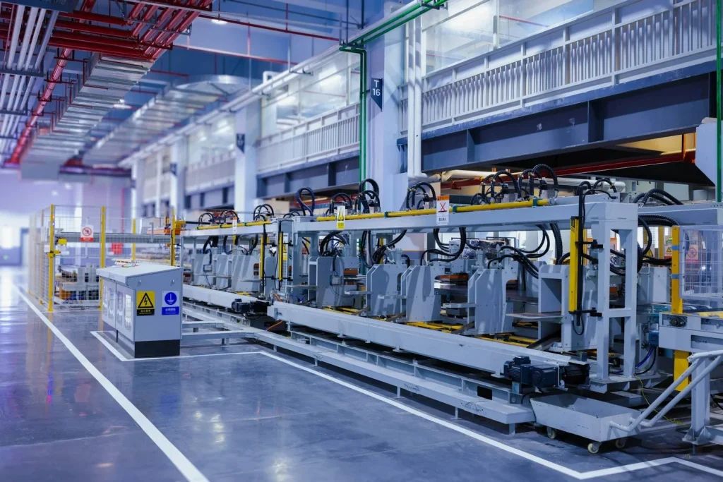 Automated manufacturing line with production equipment, overhead utility services and protected work areas.